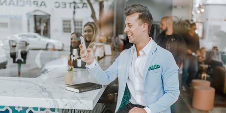 guy on his phone clicking a PPC ad